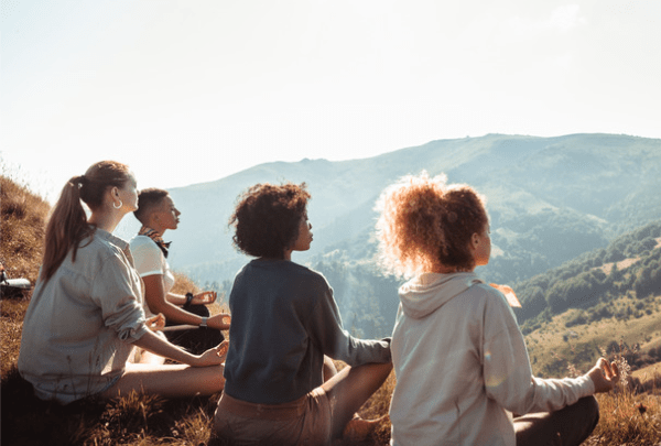 yoga students on a hill