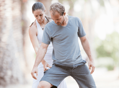 Yoga teacher guiding a student through asana safely