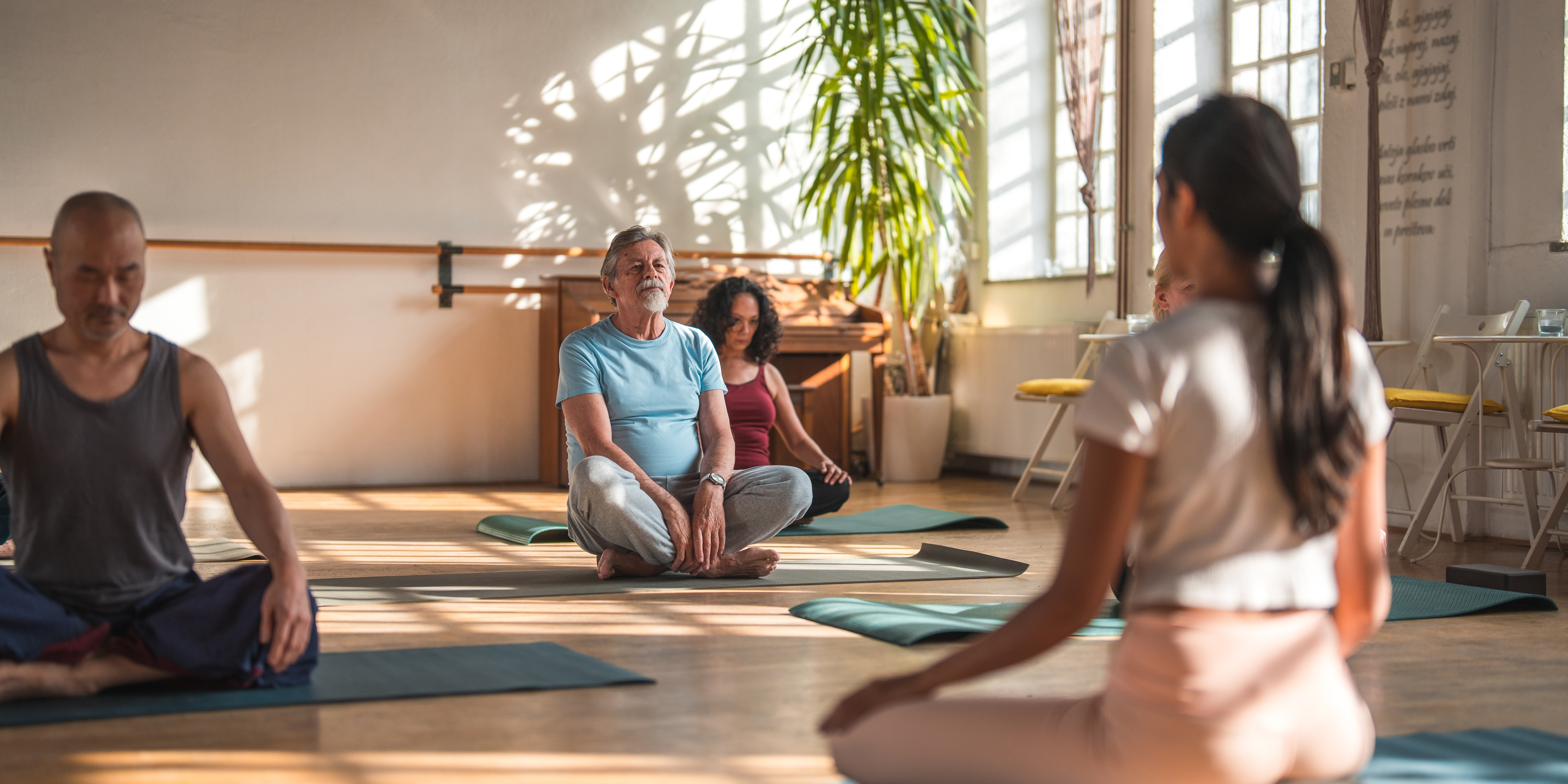 Yoga teacher leading a class through asana